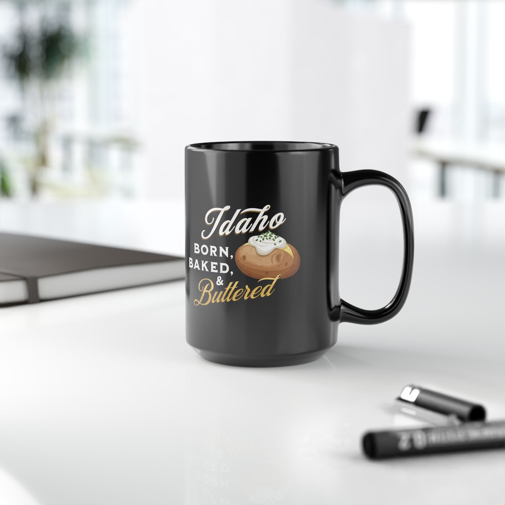 Idaho Born, Baked & Buttered Coffee Mug — Black Ceramic Tea Cup (15oz)