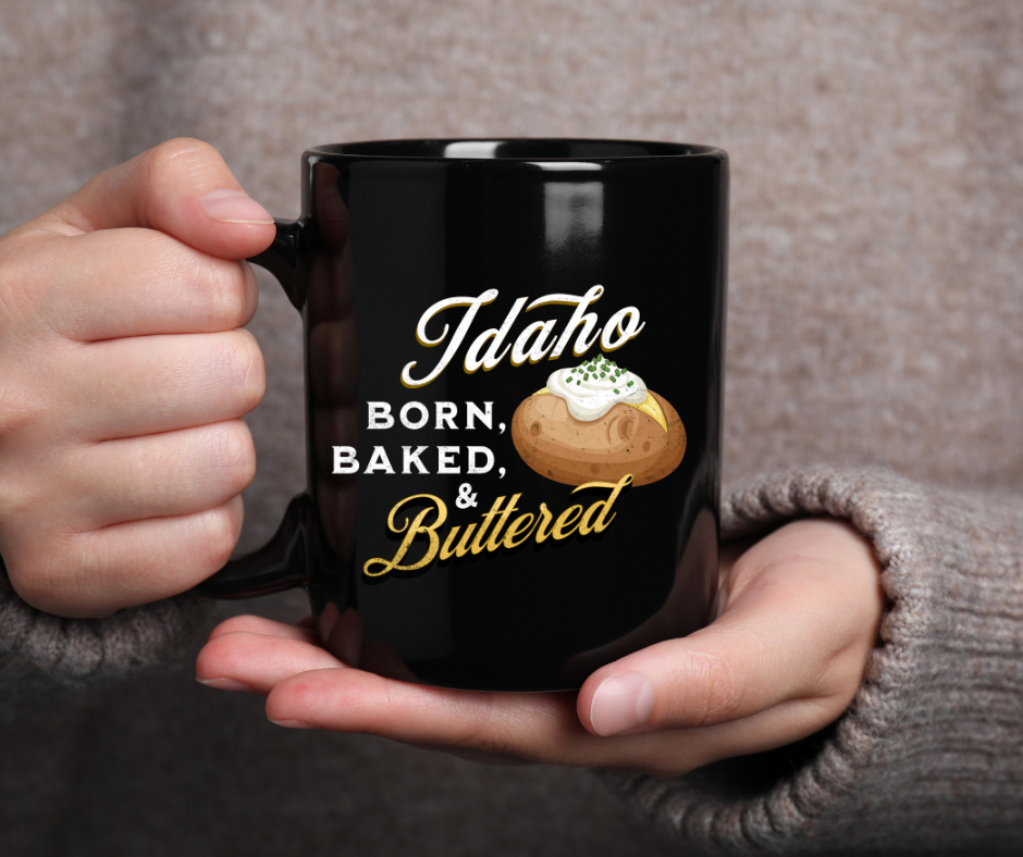 Idaho Born, Baked & Buttered Coffee Mug — Black Ceramic Tea Cup (15oz)